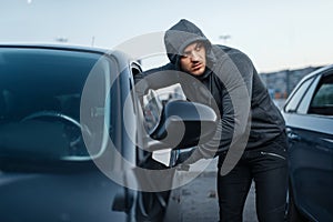 Car thief breaking door, criminal job, burglar