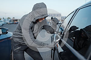 Car thief breaking door lock, criminal job