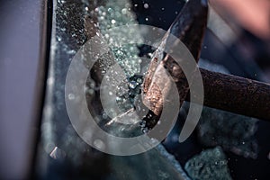 Car thief breaks the car window