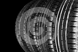 Car tire isolated on black background. Tire stack. Car tyre protector close up. Black rubber tire. Brand new car tires. Close up b