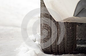 Car and tire pattern on snowy ground. close-up car tire