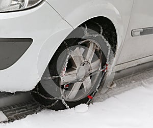 Car tire with snow chains in winter