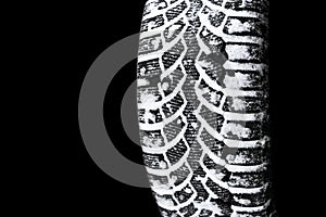 The car tire in the snow close up. Car tracks on the snow. Traces of the car in the snow. Winter tires. Tyres covered with snow at