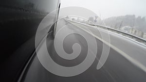 Car tire splashing water on a highway