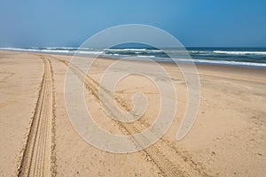 Car tire tracks in the sand of Skeleton Coast, Namibia