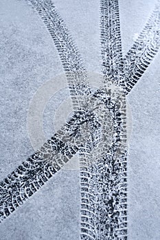 Car tire tracks in snow