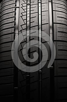 car tire, tread close-up. driving safety and aquaplaning. auto background, vertical photo
