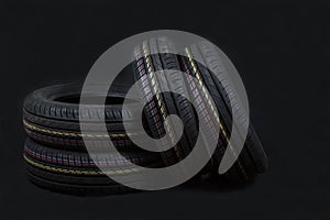 Car tires on a black background. Tire and disk stores