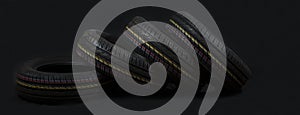 Car tires on a black background. Tire and disk stores