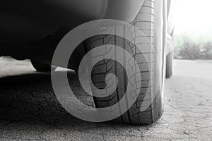 Car tires close-up. Car wheel and exhaust pipe