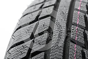 Car tires close-up Winter wheel profile structure with water drops on white background