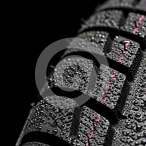 Car tires close-up Winter wheel profile structure with waterdrops on blue black background