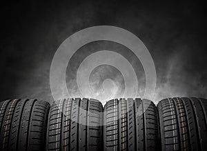 Car tires on a dark background.