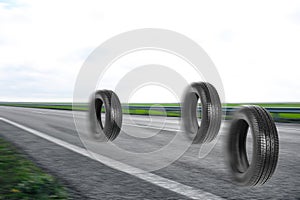 Car tires rolling on asphalt highway
