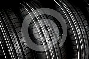 Car tires in row isolated on black