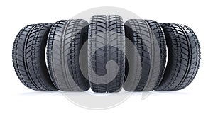 Car tires in row on white background. New black wheel tyres for