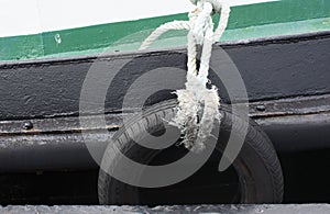 Car tires used as a fender for a ship