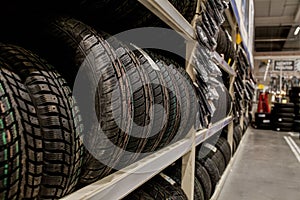 Car tires and wheels at warehouse in tire store