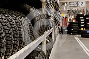 Car tires and wheels at warehouse in tire store