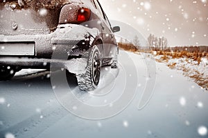 Car tires on winter road covered with snow