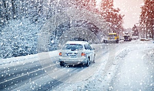 Car tires on winter road covered with snow.