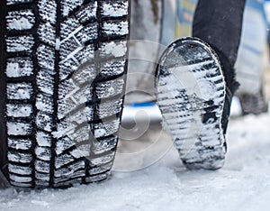 Car tires on the winter road are covered with snow