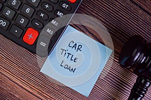 Car Title Loan write on sticky notes isolated on Wooden Table