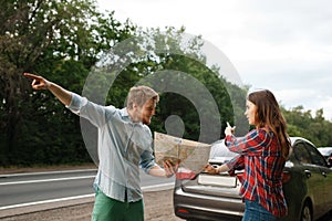 Car tourists with map having quarrel, road travel