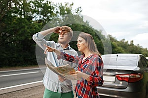 Car tourists with map having quarrel, road travel