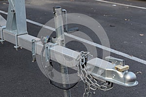 Car tow hitch with trailer lock handle and electrical socket close up side view, safety driving with a trailer connection