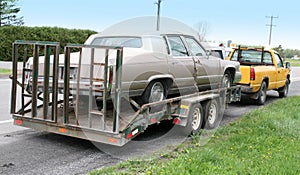 Car towed on a flatbed truck