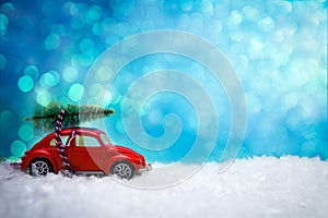 Car toy carrying a Christmas tree