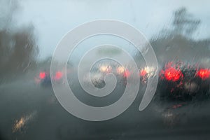 Car traffic driving with heavy rain on car windscreen - State Hi