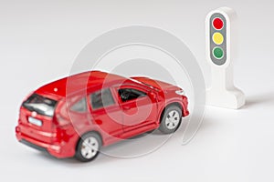 A car and traffic llight on a white background. Traffic Laws photo