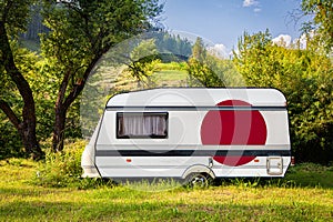 A car trailer, a motor home, painted in the national flag