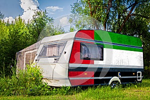 A car trailer, a motor home, painted in the national flag