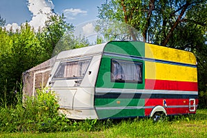 A car trailer, a motor home, painted in the national flag