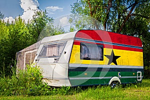 A car trailer, a motor home, painted in the national flag