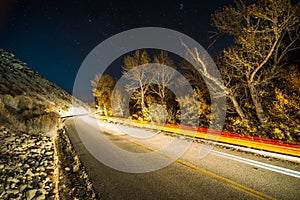 Car trails on road at night in sierra mountains california