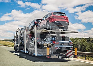 Car transporter moving on a road.