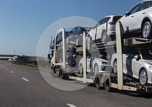Car transporter transports cars on highway
