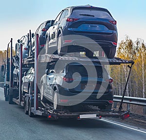 Car transporter truck on semi-trailer on highway