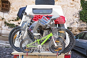 Car transports bicycles on a rack in early morning