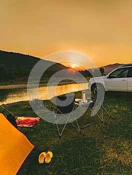 car travel concept camping place near mountains river