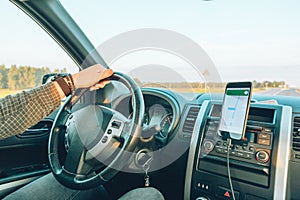 car travel concept man hand on steering wheel speedway