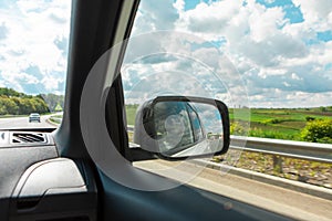 car travel concept road reflection in rear mirror view