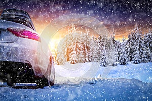 Car travel in the mountains. Snowy winter mountain background.