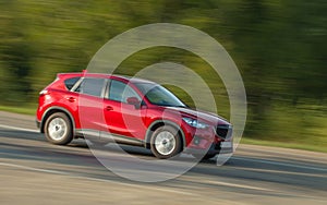 Car travels down the road at high speed. Motion blur