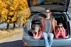 Car trip on autumn family vacation, happy mother and kids travel