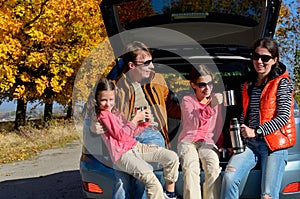 Car trip on autumn family vacation, happy parents and kids travel